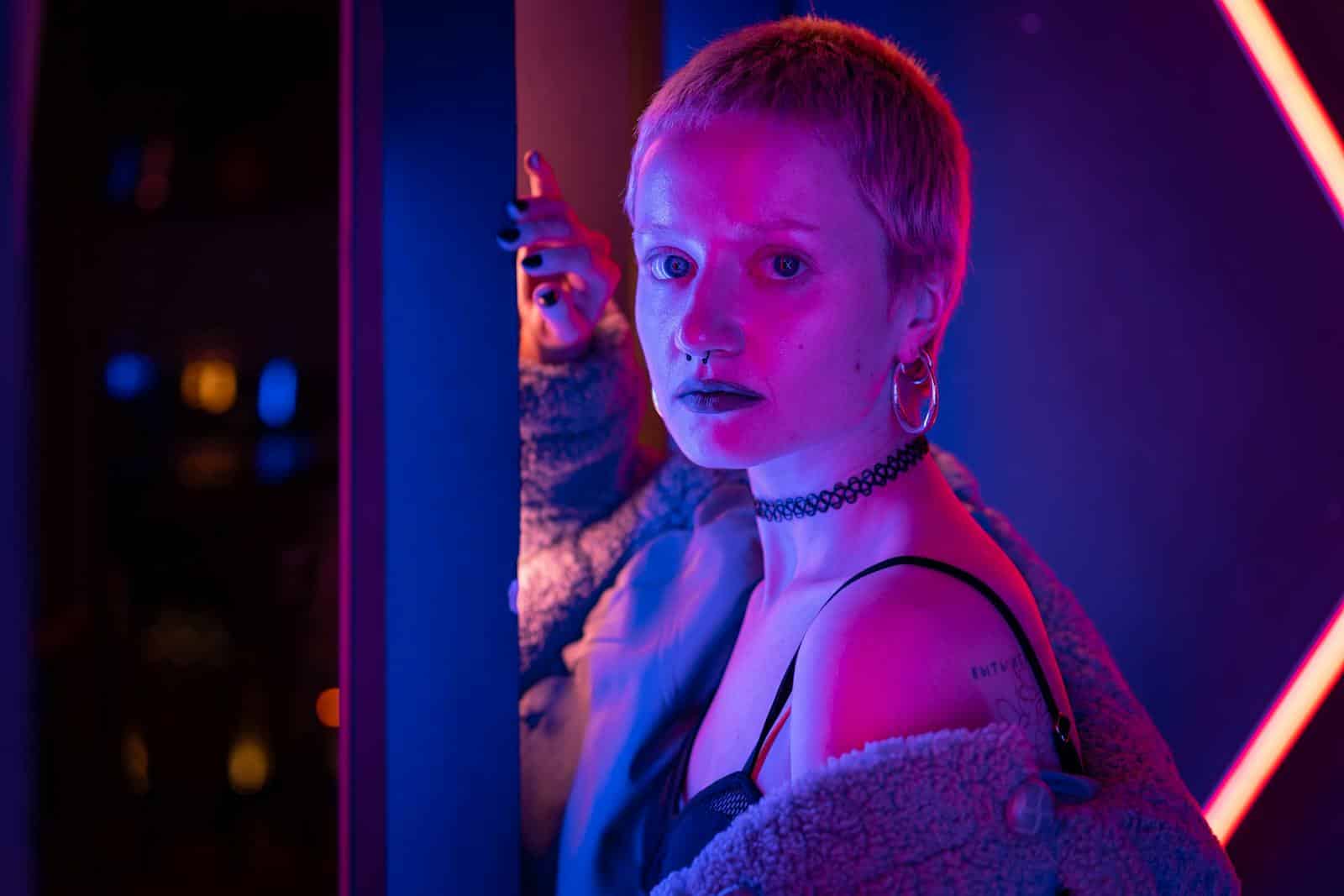 A striking portrait of a woman in neon lights, showcasing a modern and edgy style.