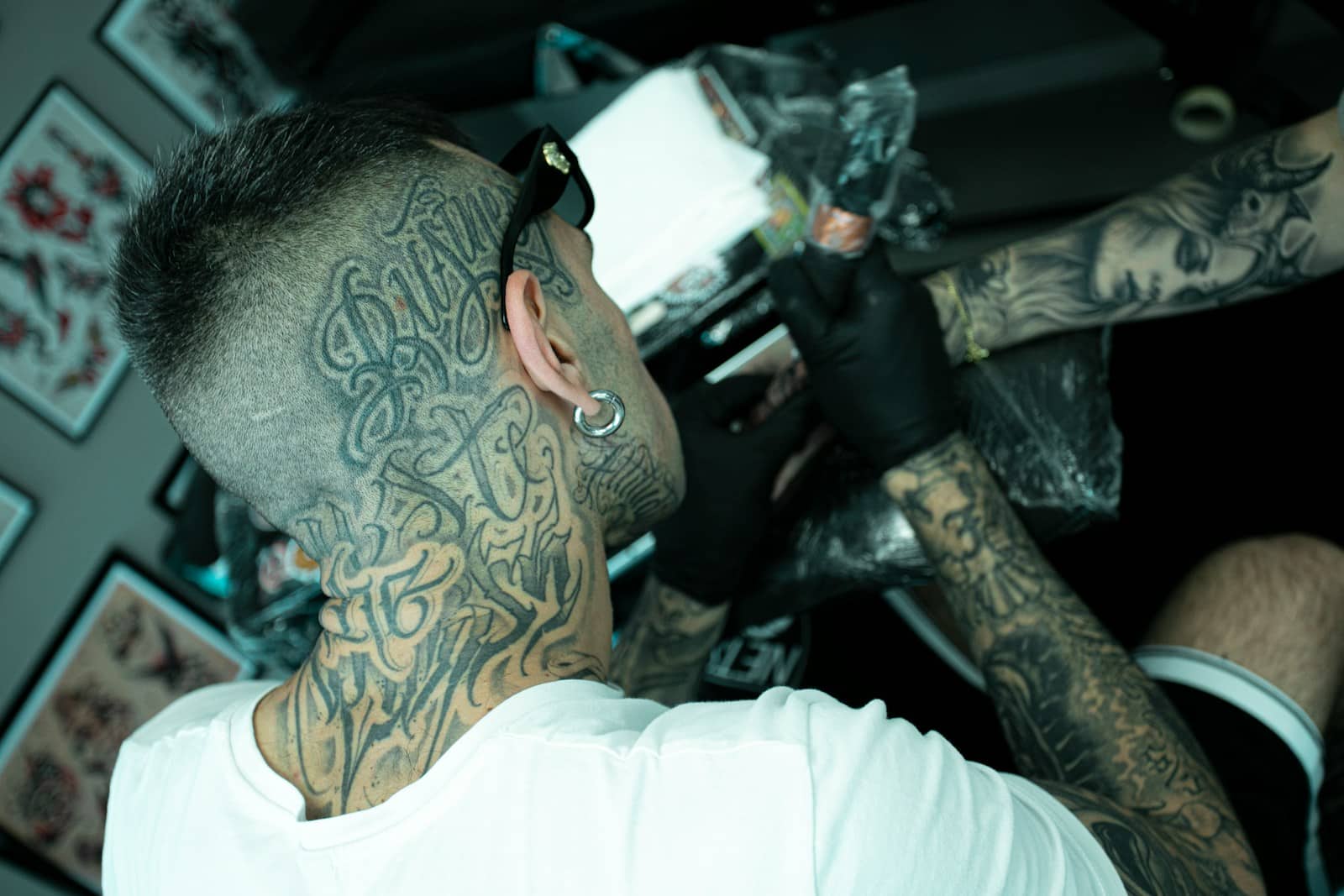 A man with lots of tattoos on his face