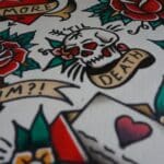 white, green, and red skull and flower print textile