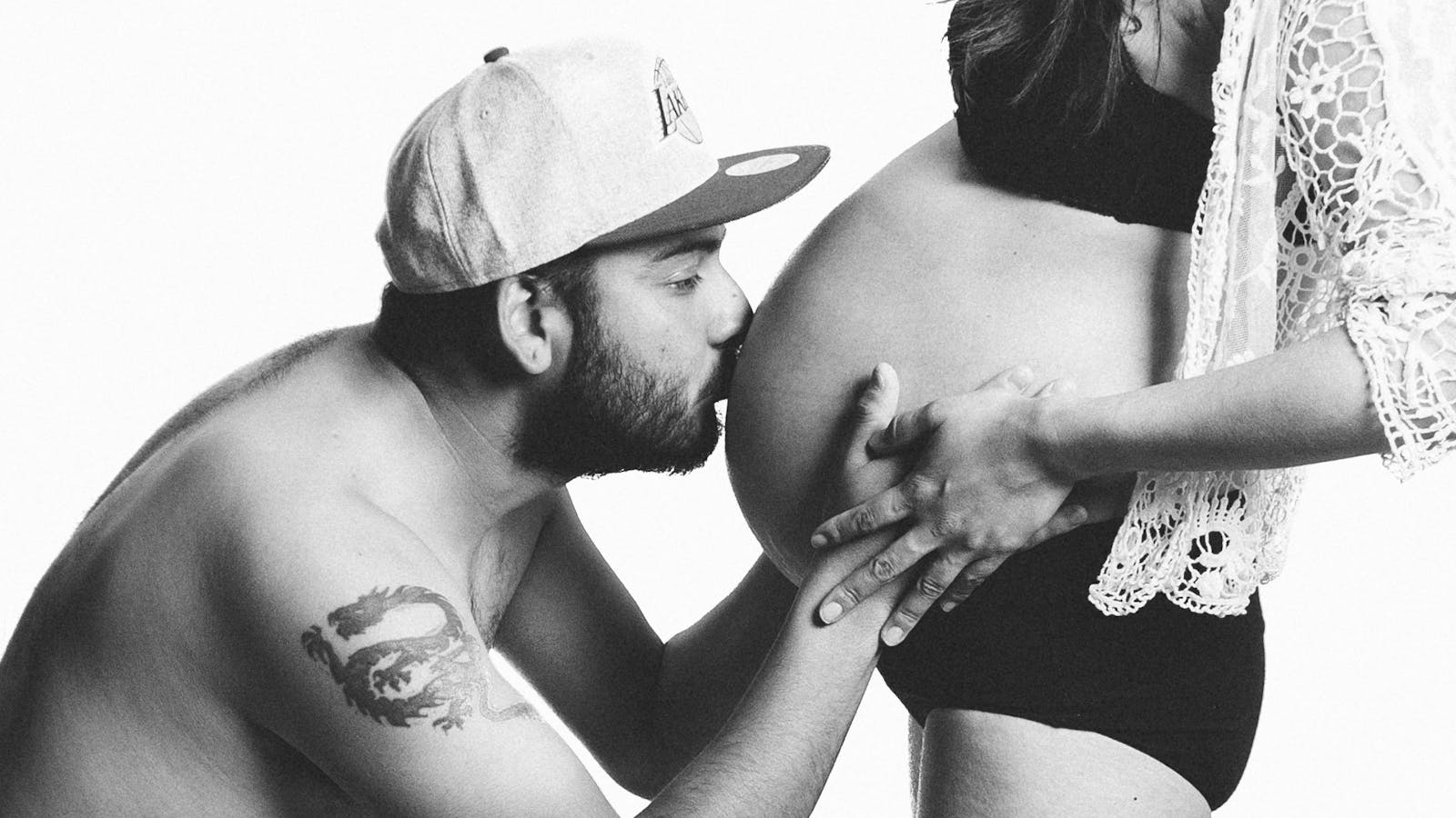 A couple sharing an intimate moment during pregnancy, highlighting love and parenthood.