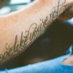 shallow focus photography of forearm tattoo