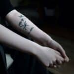 a person with a flower tattoo on their arm
