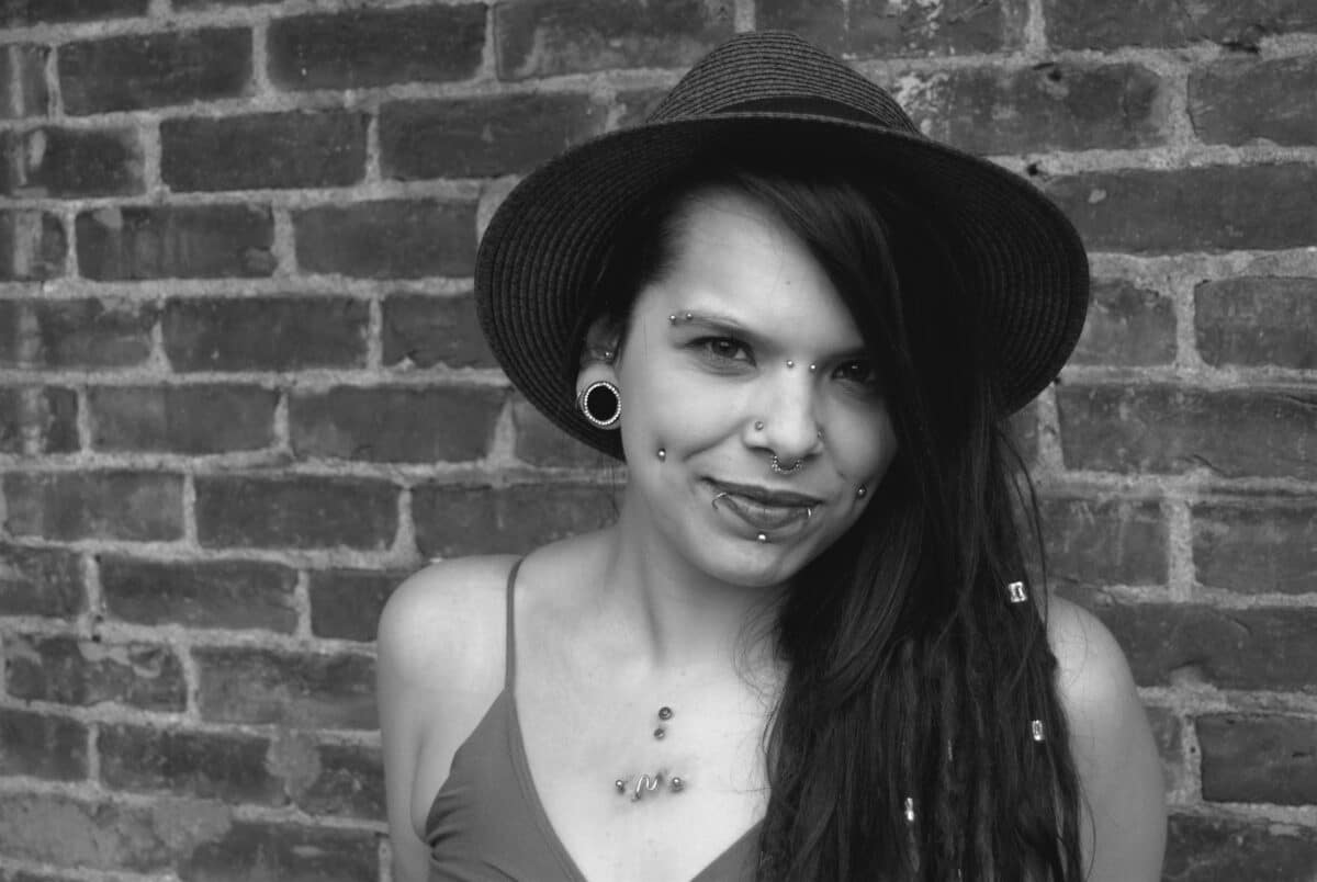 a woman with long hair wearing a hat