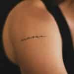 music bicep tattoo