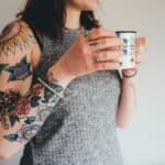 woman holding white ceramic mug
