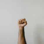 persons right foot on white wall