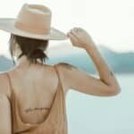 topless woman wearing white cowboy hat